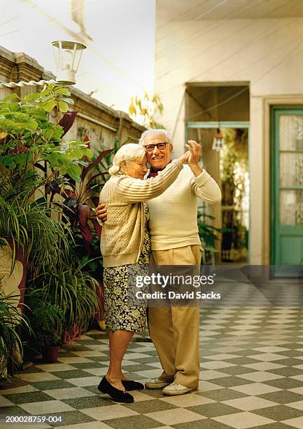 elderly couple dancing, portrait - tanz stock-fotos und bilder