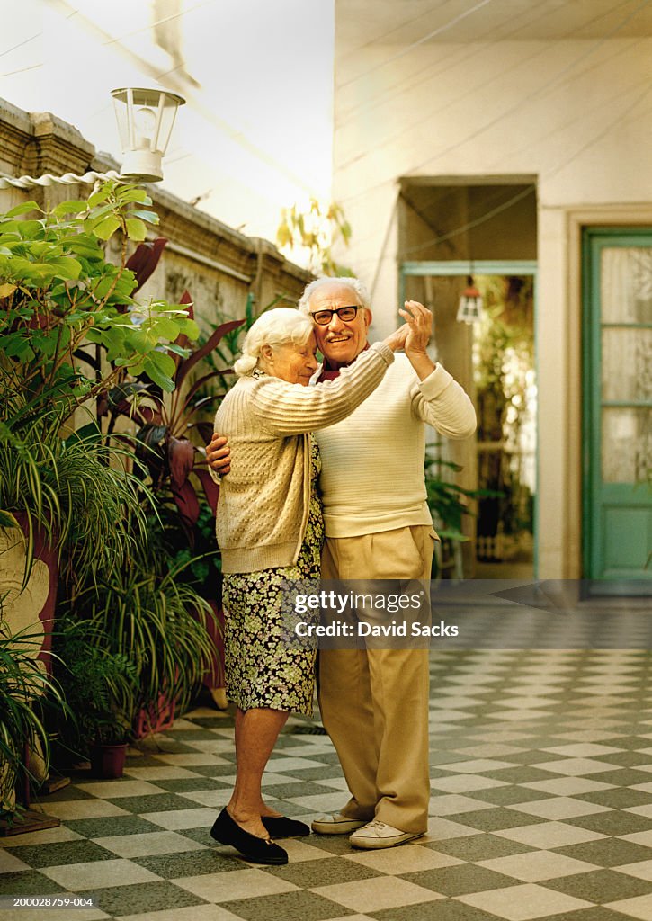 Elderly couple dancing, portrait
