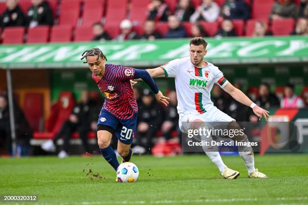 Xavi Simons of RB Leipzig and Ermedin Demirovic of FC Augsburg battle for the ball during the Bundesliga match between FC Augsburg and RB Leipzig at...