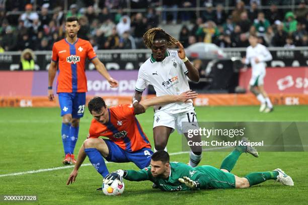 Marcel Schuhen and Christoph Zimmermann of SV Darmstadt 98 clash with Kouadio Kone of Borussia Mönchengladbach during the Bundesliga match between...