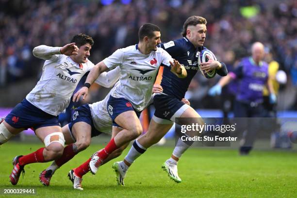 Kyle Steyn of Scotland runs with the ball whilst under pressure during the Guinness Six Nations 2024 match between Scotland and France at BT...