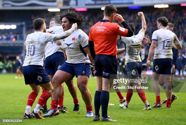Posolo Tuilagi of France celebrates with teammate Matthieu Jalibert following the team's victory during the Guinness Six Nations 2024 match between...