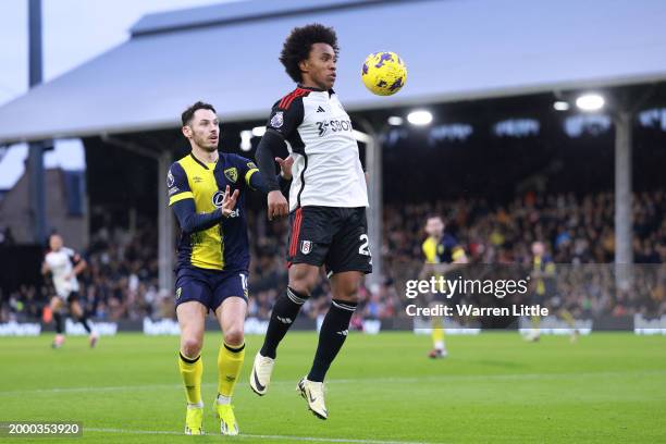 Willian of Fulham controls the ball under pressure from Adam Smith of AFC Bournemouth during the Premier League match between Fulham FC and AFC...