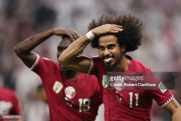 Akram Afif of Qatar celebrates scoring his team's second goal from the penalty spot during the AFC Asian Cup final match between Jordan and Qatar at...