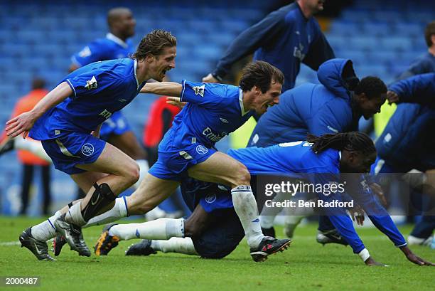 Chelsea players Emmanuel Petit, Gianfranco Zola and Mario Melchiot celebrate qualification to the Champions League with team-mates after the FA...