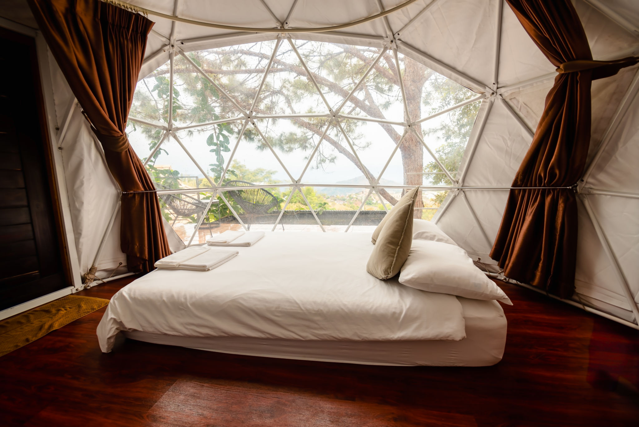 White bed inside a large and luxury tent, camping tent with bed. White bed inside a large and luxury tent, camping tent with bed.