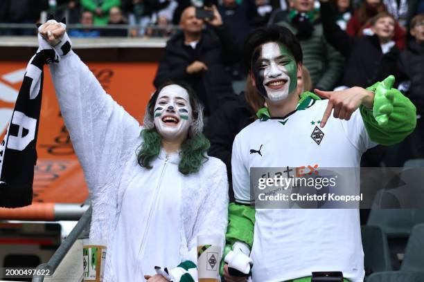 Fans of Moenchengladbach dressed in a carnival costums react during the Bundesliga match between Borussia Mönchengladbach and SV Darmstadt 98 at...