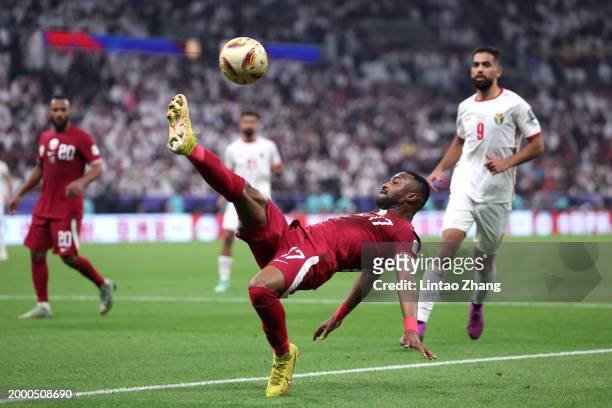 Ismaeel Mohammad of Qatar kicks the ball during the AFC Asian Cup final match between Jordan and Qatar at Lusail Stadium on February 10, 2024 in...