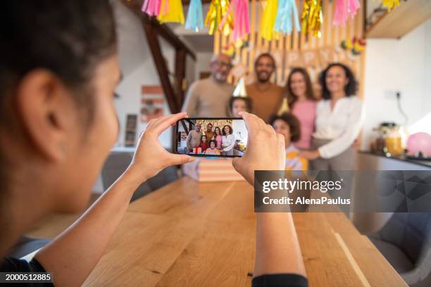 taking a photo on birthday party - older woman birthday stock pictures, royalty-free photos & images