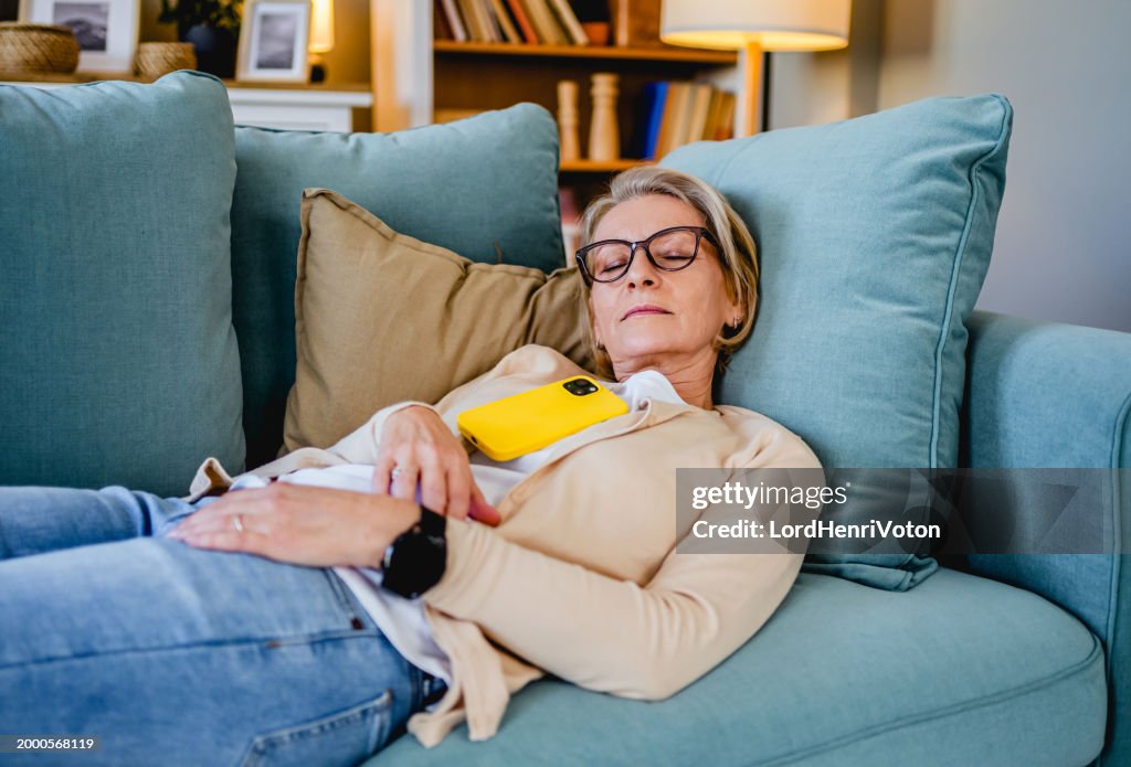 Tired woman taking a nap on the sofa