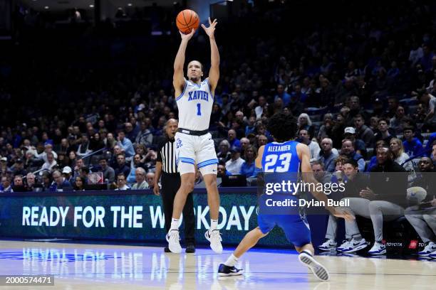 Desmond Claude of the Xavier Musketeers attempts a shot while being guarded by Trey Alexander of the Creighton Blue Jays in the first half at the...