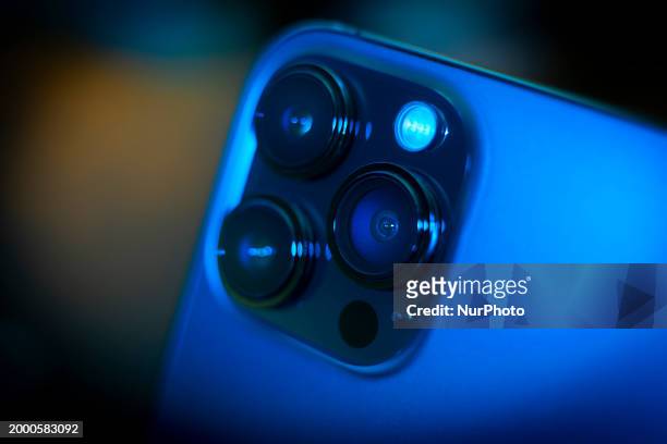An iPhone with camera and lens is seen in this illustration photo taken on 13 February, 2024 in Warsaw, Poland.