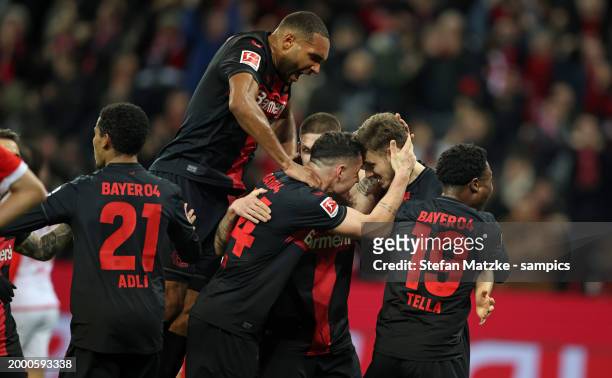 Josip Stanisic of Bayer Leverkusen celebrates as he scores the goal with his player during the Bundesliga match between Bayer 04 Leverkusen and FC...