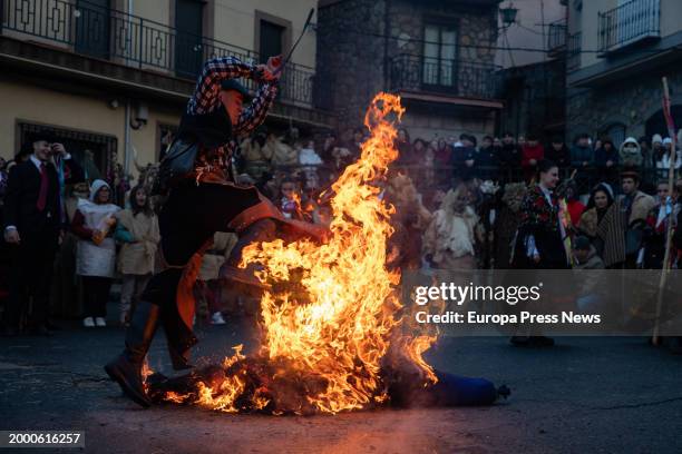 Man jumps in the burning of the pelele, during the Harramachos festival, on 10 February, 2024 in Navalacruz, Avila, Castilla y Leon, Spain. The...