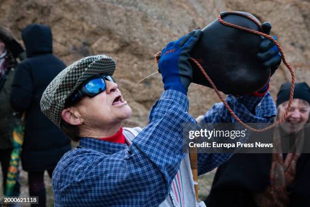 Man drinks in a boot, during the Harramachos festival, on 10 February, 2024 in Navalacruz, Avila, Castilla y Leon, Spain. The Harramachos party is a...