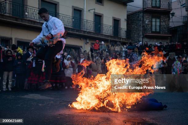 Man jumps in the burning of the pelele, during the Harramachos festival, on 10 February, 2024 in Navalacruz, Avila, Castilla y Leon, Spain. The...