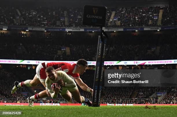 Fraser Dingwall of England scores his team's second try after evading the tackle attempt from Mason Grady of Wales during the Guinness Six Nations...