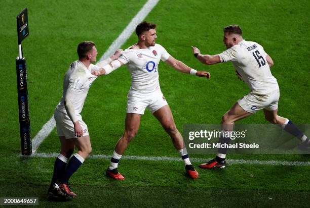 Fraser Dingwall of England celebrates scoring his team's second try with teammates Henry Slade and Freddie Steward during the Guinness Six Nations...