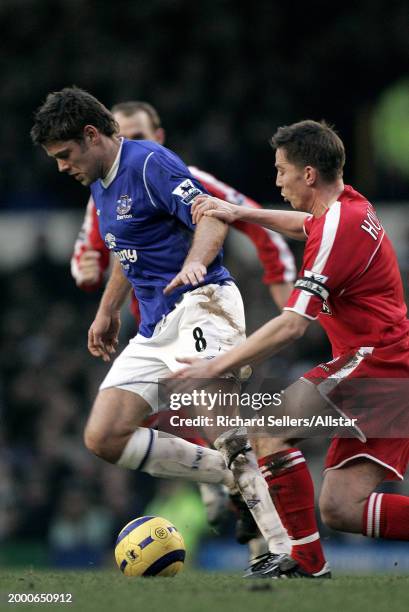 James Beattie of Everton and Matt Holland of Charlton Athletic challenge during the Premier League match between Everton and Charlton Athletic at...