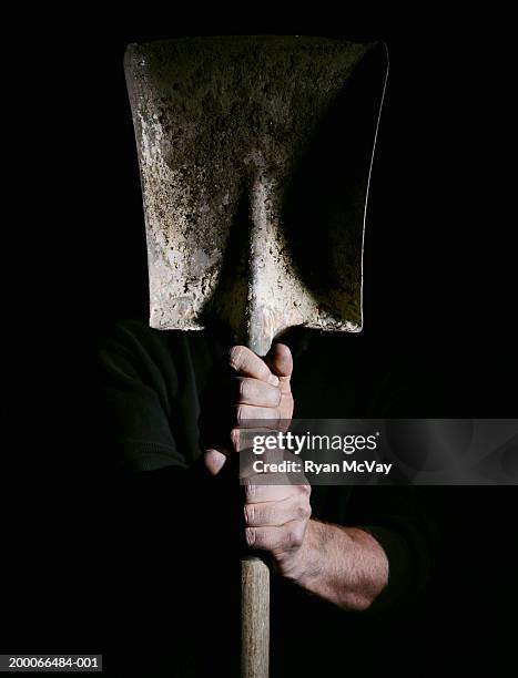 man holding a shovel, focus on hands - spaten stock-fotos und bilder
