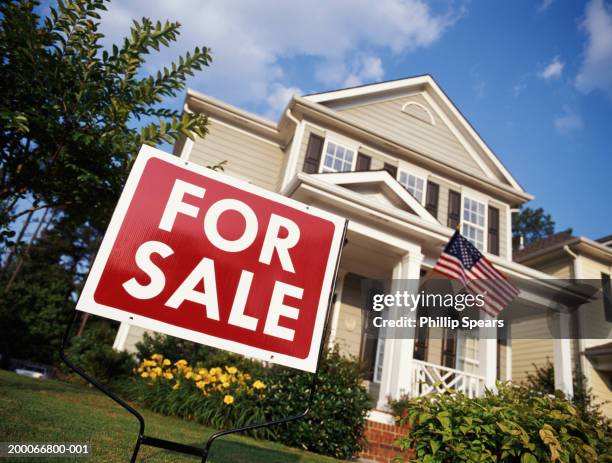 house with american flag and 'for sale' sign, low angle view - house for sale stock pictures, royalty-free photos & images