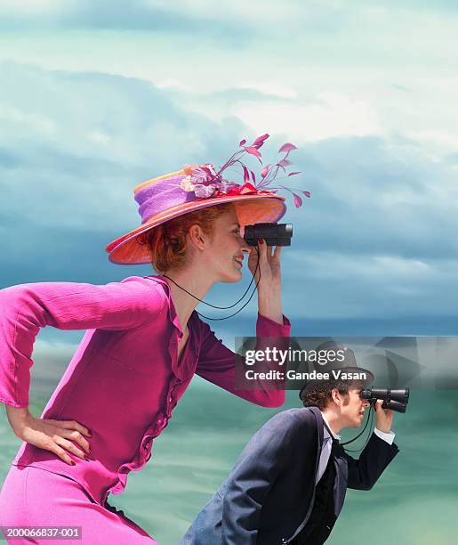young couple in formal wear looking through binoculars outdoors - woman hat photos et images de collection