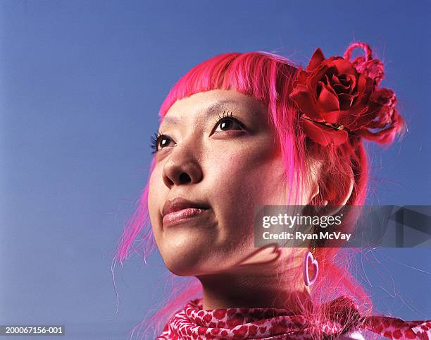 young woman with pink hair looking away, portrait - asian hair stock-fotos und bilder