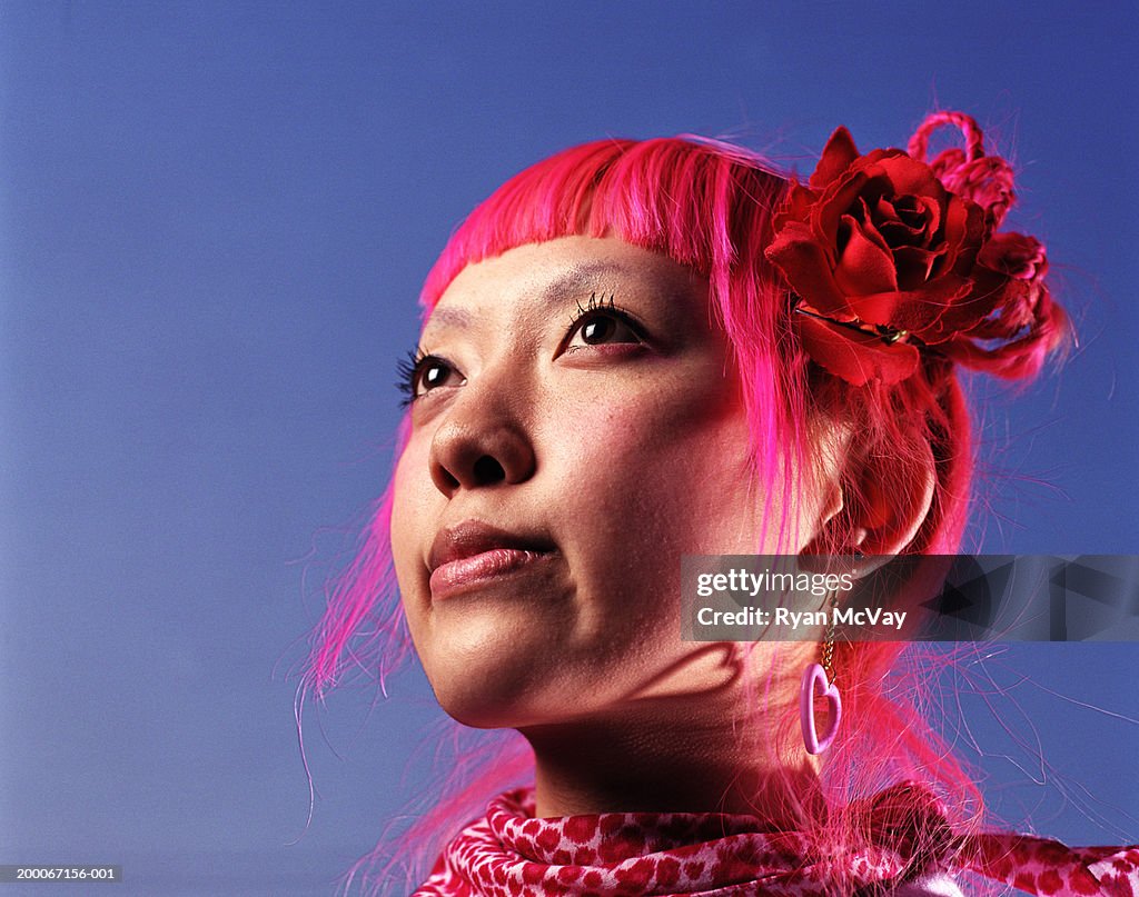 Young woman with pink hair looking away, portrait