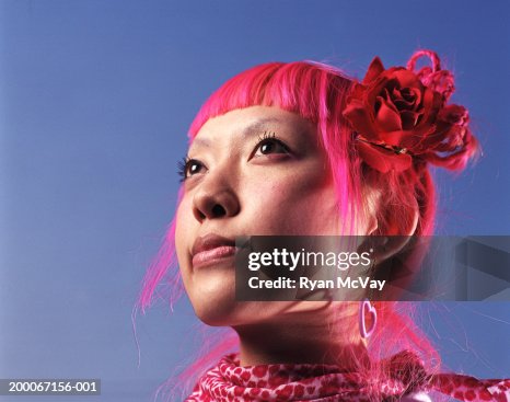 Young woman with pink hair looking away, portrait Young woman with pink hair looking away, portrait