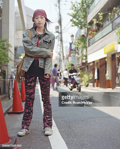 young woman standing on urban sidewalk, portrait - harajuku fashion stock pictures, royalty-free photos & images