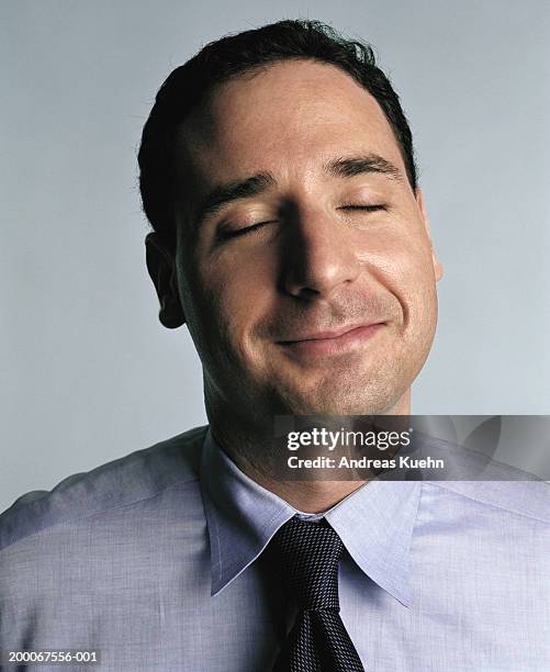 businessman with eyes closed, smiling, close up - relief emotion stock pictures, royalty-free photos & images