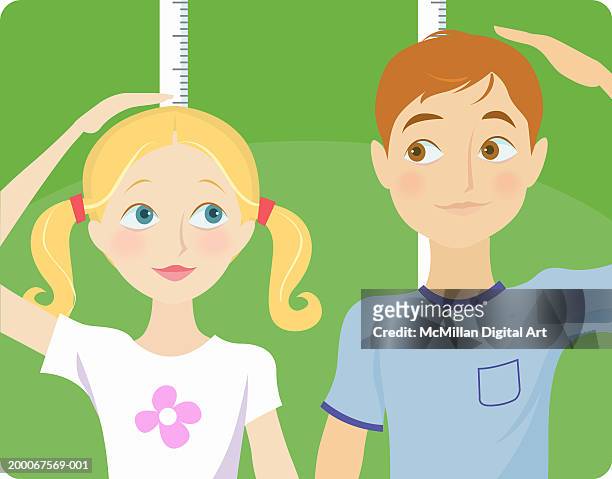 ilustrações, clipart, desenhos animados e ícones de boy and girl (8-10) measuring height with rulers - measuring height