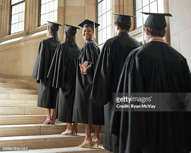 graduate in line climbing stairs, turning to wave - graduation gown 個照片及圖片檔
