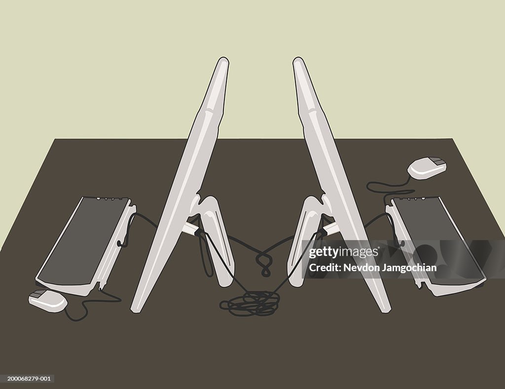 Two flat screen computers on desk, elevated view