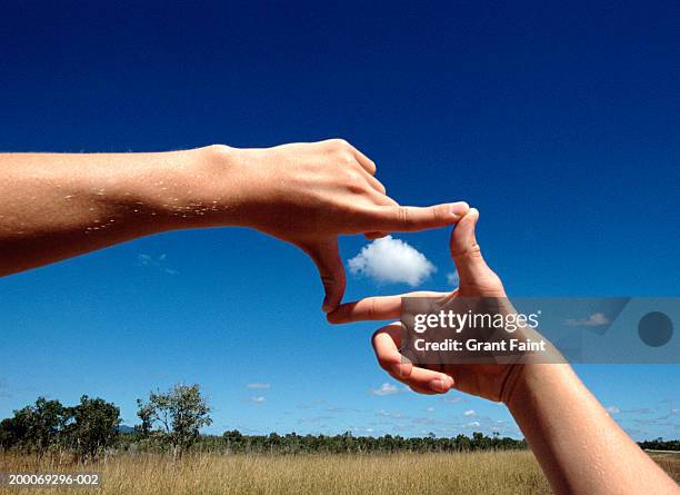 man framing cloud, close-up of hands - looking through an object stock pictures, royalty-free photos & images