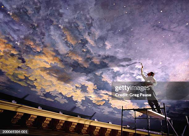 man painting mural on ceiling, low angle view (digital composite) - painting stock-fotos und bilder