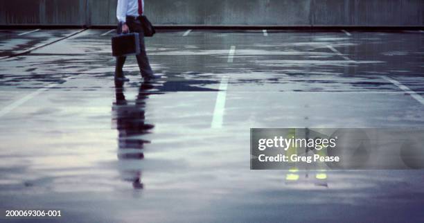 businessman in wet parking lot, night - bad parking job stock pictures, royalty-free photos & images