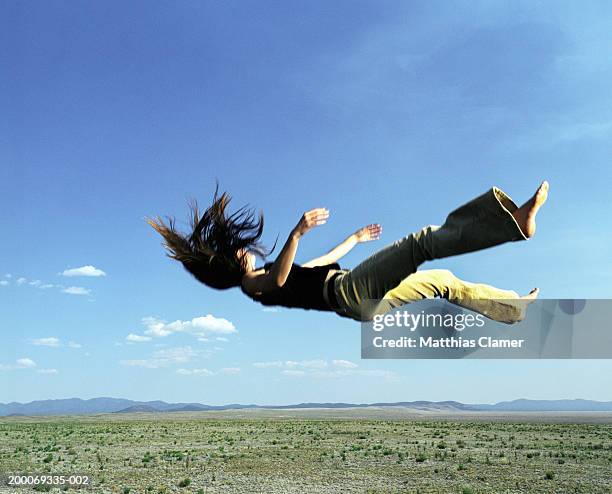 woman falling from sky - person falling mid air stock pictures, royalty-free photos & images