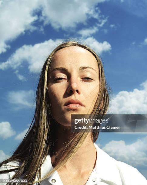 woman squinting, hair blowing, portrait, close up - squinting stock pictures, royalty-free photos & images