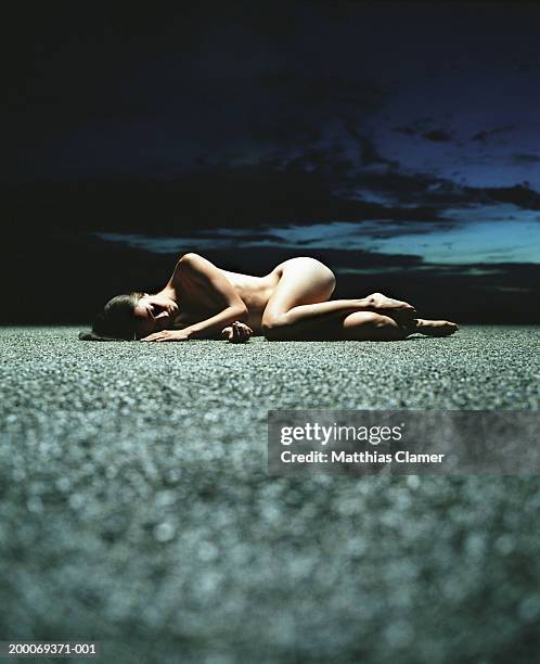 naked woman sleeping on gravel - bare corpse stock pictures, royalty-free photos & images