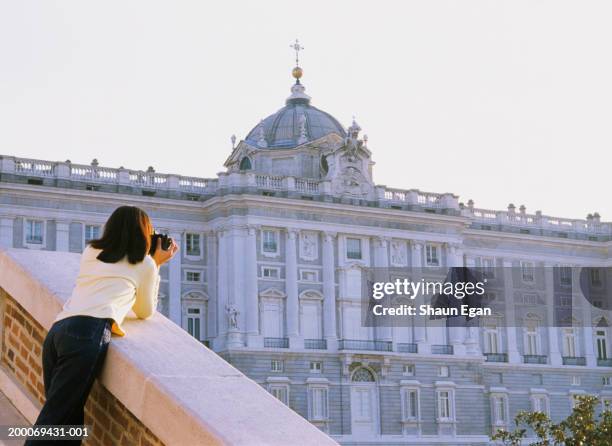 spain, madrid, woman taking photograph of royal palace, rear view - マドリード王宮 ストックフォトと画像