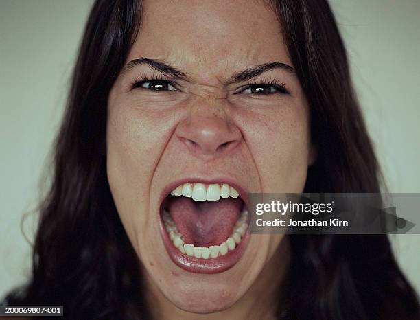 young woman screaming, close-up - grimm stock-fotos und bilder