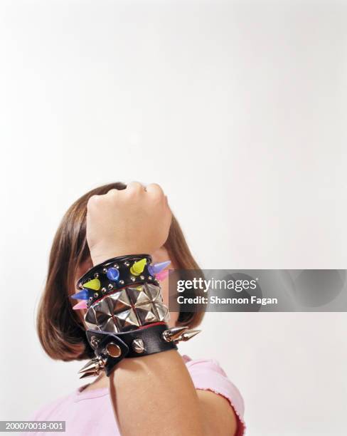 girl (10-12) wearing spiked bracelet, close-up - spiked bracelet stock pictures, royalty-free photos & images