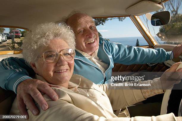 elderly couple in car, man's arm around woman's shoulders, portrait - big hug stock pictures, royalty-free photos & images