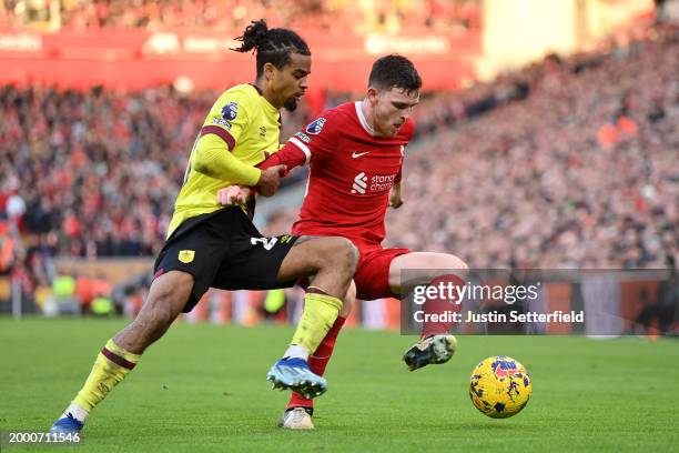 Andrew Robertson of Liverpool is tackled by Lorenz Assignon of Burnley during the Premier League match between Liverpool FC and Burnley FC at Anfield...