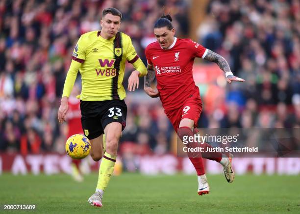 Darwin Nunez of Liverpool and Maxime Esteve of Burnley compete for the ball during the Premier League match between Liverpool FC and Burnley FC at...
