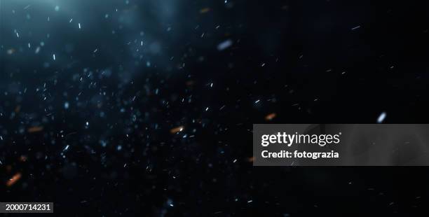 blurred particles against dark background - dusty light stock pictures, royalty-free photos & images
