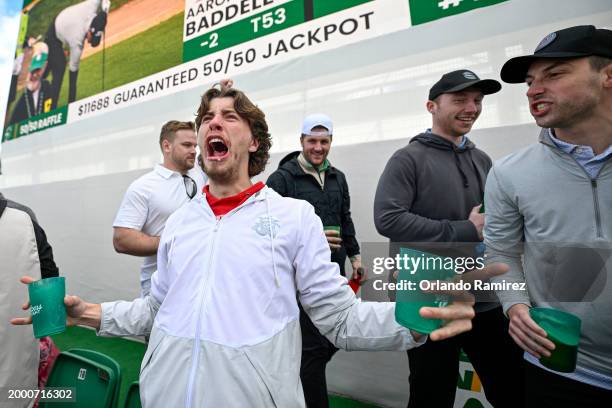 Fans celebrate on the 16th green during the continuation of the second round of the WM Phoenix Open at TPC Scottsdale on February 10, 2024 in...