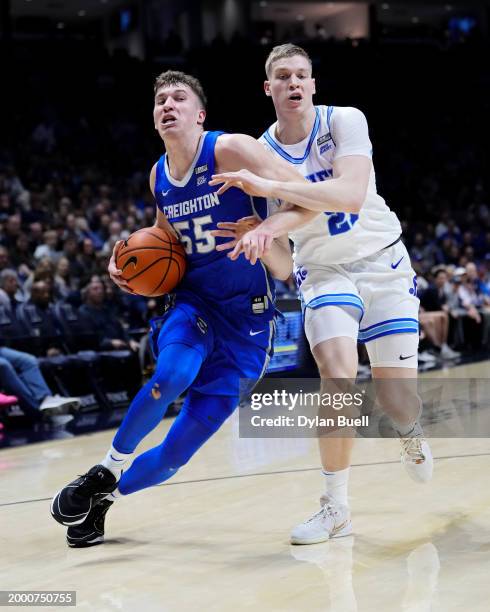 Baylor Scheierman of the Creighton Blue Jays dribbles the ball while being guarded by Saša Ciani of the Xavier Musketeers in the second half at the...