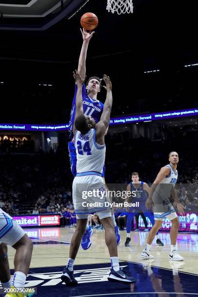 Ryan Kalkbrenner of the Creighton Blue Jays attempts a shot while being guarded by Abou Ousmane of the Xavier Musketeers in the second half at the...